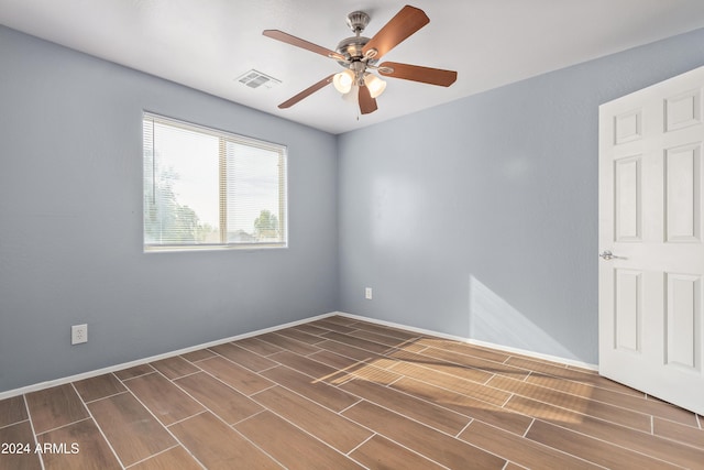 spare room with ceiling fan and dark hardwood / wood-style floors