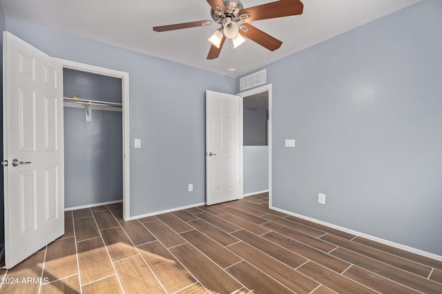 unfurnished bedroom with a closet, ceiling fan, and dark wood-type flooring