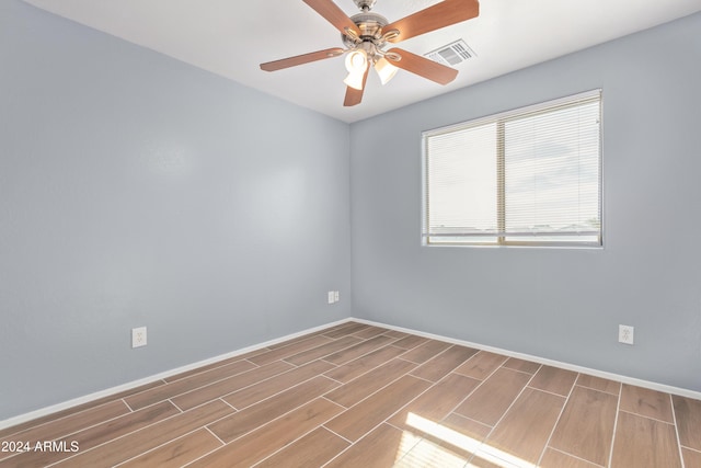 spare room featuring hardwood / wood-style flooring and ceiling fan