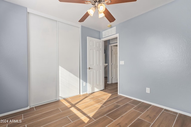 interior space with dark hardwood / wood-style floors and ceiling fan