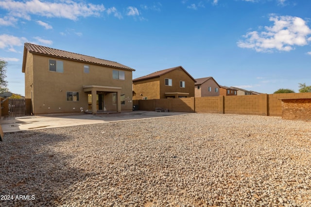 rear view of property featuring a patio area