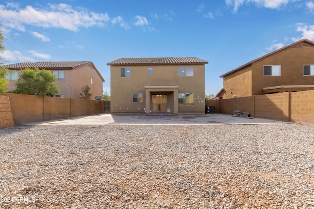 back of property with a patio