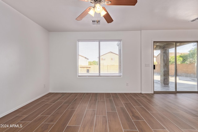 unfurnished room featuring ceiling fan and dark hardwood / wood-style floors