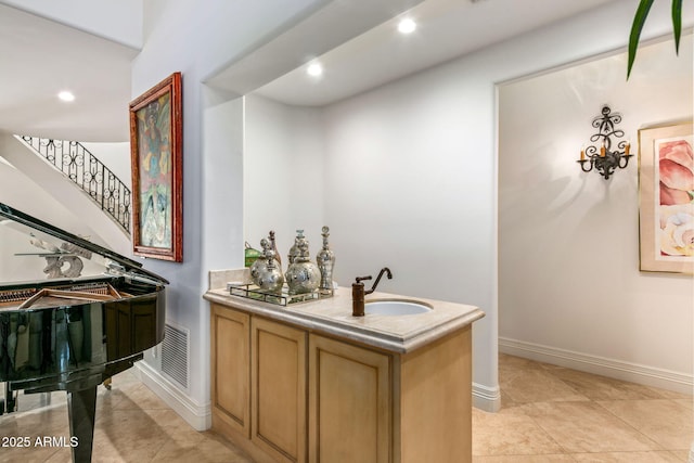 bar featuring sink and light tile patterned floors