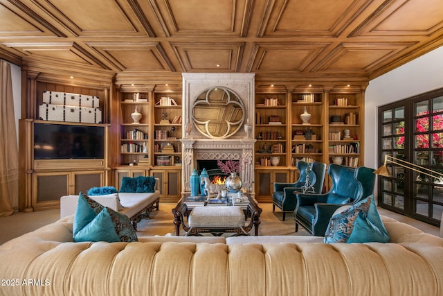 carpeted living room featuring a large fireplace and built in features