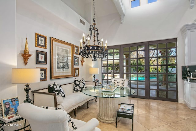 living area featuring french doors, a towering ceiling, and light tile patterned floors