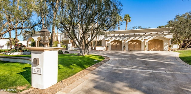 mediterranean / spanish-style home with a garage and a front yard