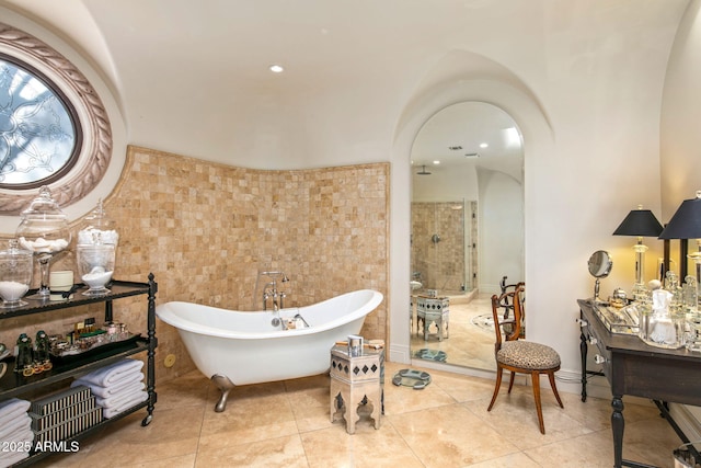 bathroom featuring independent shower and bath and tile patterned floors