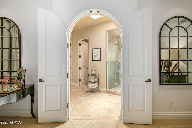 hall with light tile patterned floors