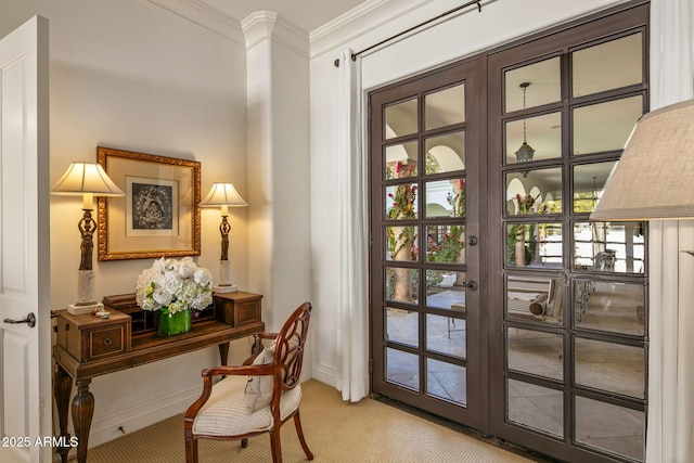 doorway to outside featuring ornamental molding, a wealth of natural light, light colored carpet, and french doors