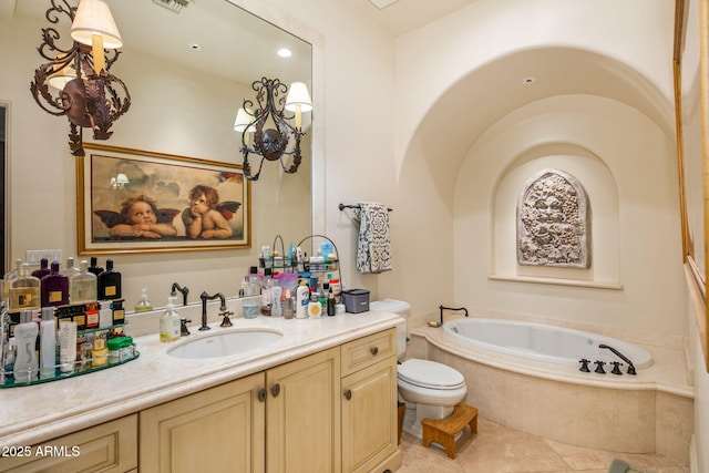 bathroom featuring tile patterned flooring, vanity, and a relaxing tiled tub