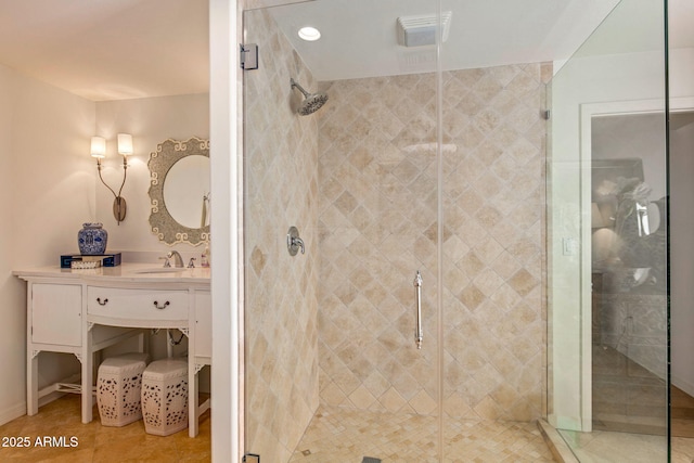 bathroom featuring an enclosed shower, vanity, and tile patterned flooring