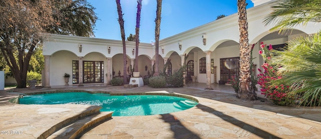 view of pool featuring french doors and a patio area