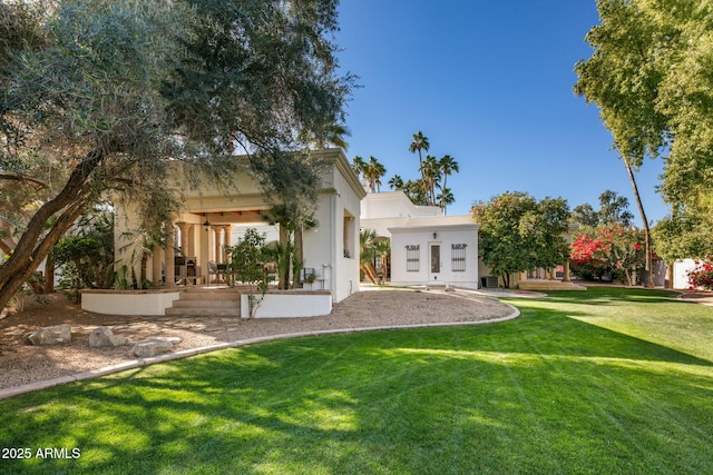 rear view of property featuring a yard