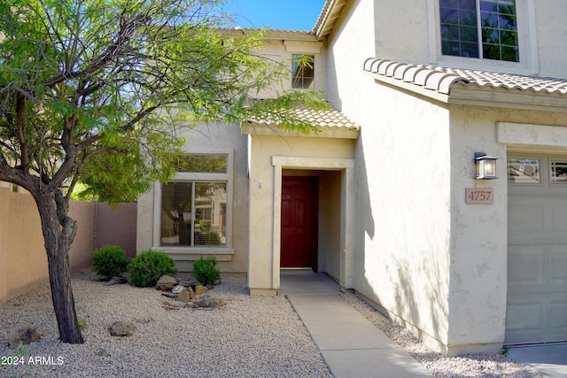 view of exterior entry featuring a garage