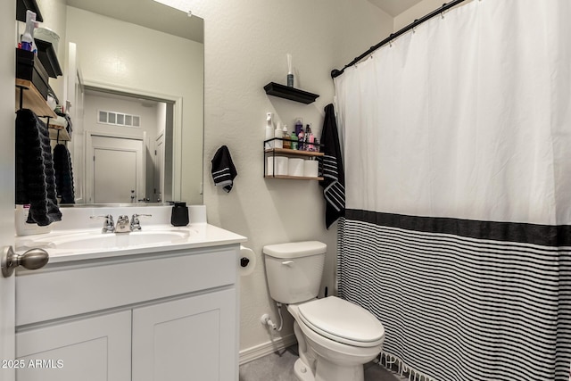 bathroom featuring vanity and toilet