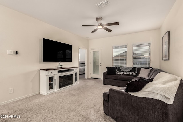 living room with ceiling fan and light carpet