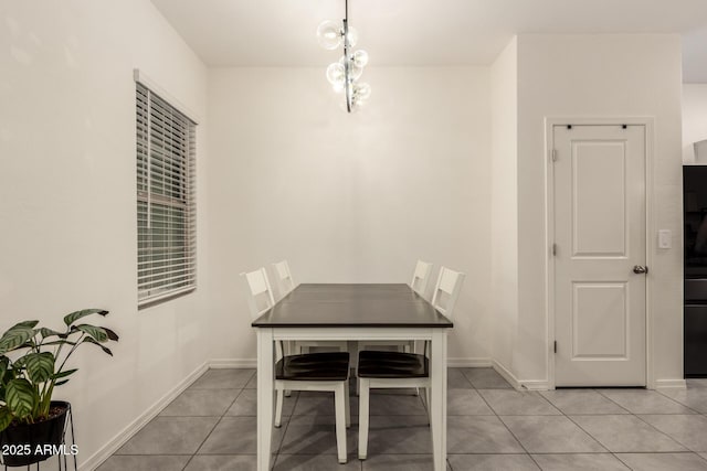 unfurnished dining area featuring an inviting chandelier and light tile patterned floors