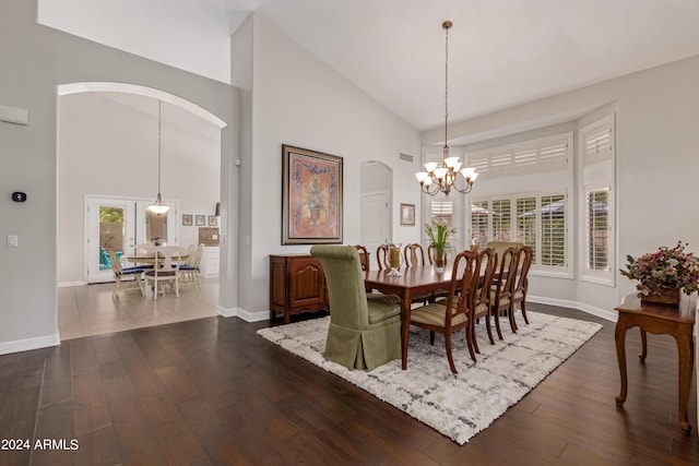 dining space featuring dark hardwood / wood-style flooring, a wealth of natural light, and high vaulted ceiling