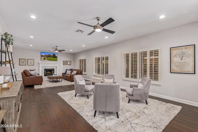 living room with dark hardwood / wood-style floors and ceiling fan