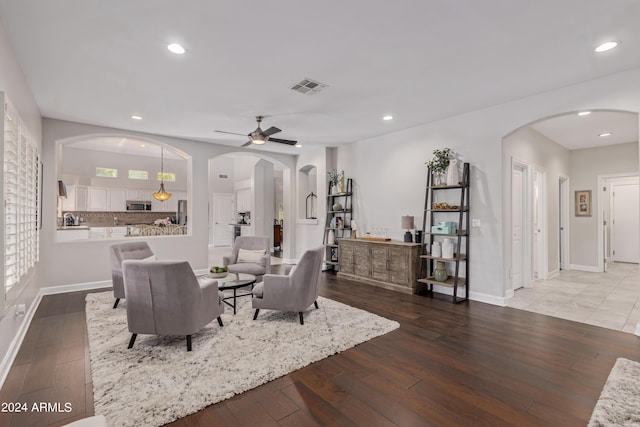 living room featuring ceiling fan and wood-type flooring