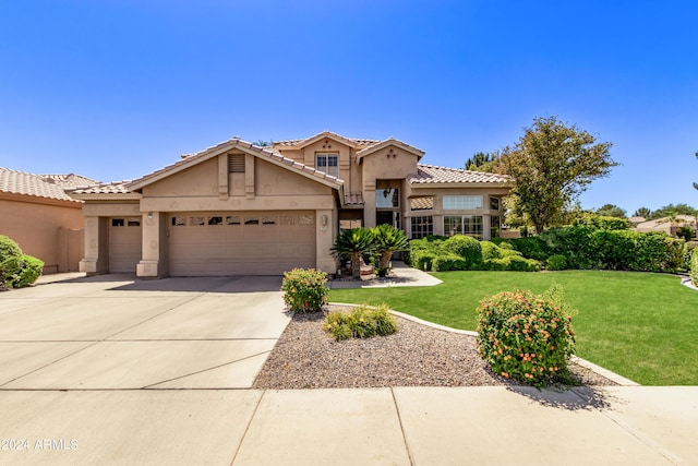 mediterranean / spanish-style house with a garage and a front yard