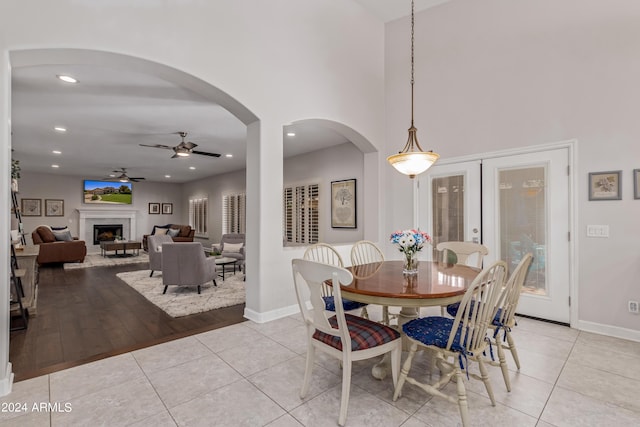 tiled dining space featuring ceiling fan