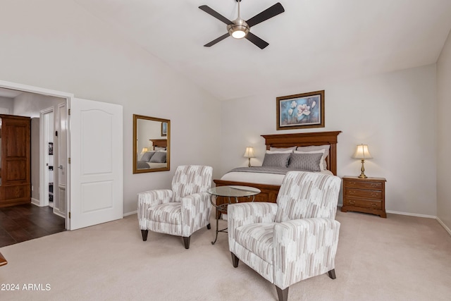 carpeted bedroom with ceiling fan and vaulted ceiling