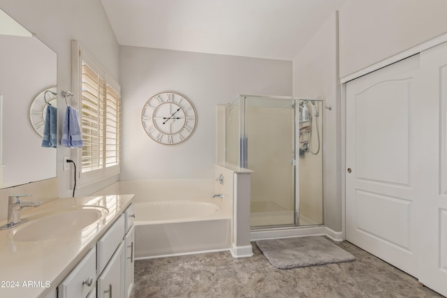 bathroom featuring vanity and independent shower and bath