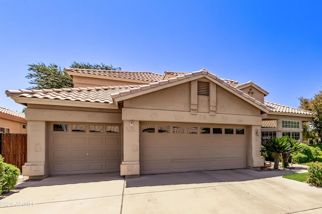 mediterranean / spanish home featuring a garage