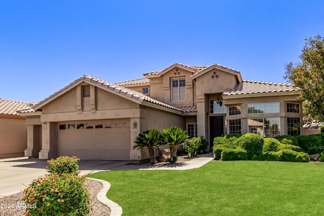 mediterranean / spanish-style house with a garage and a front yard