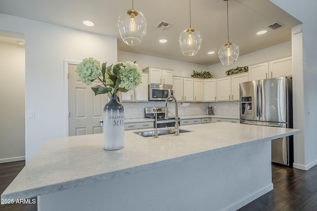 10925 E Toluca Ave, Mesa, AZ 85212 - kitchen featuring appliances with stainless steel finishes, a sink, decorative backsplash, dark wood-style floors, and white cabinetry