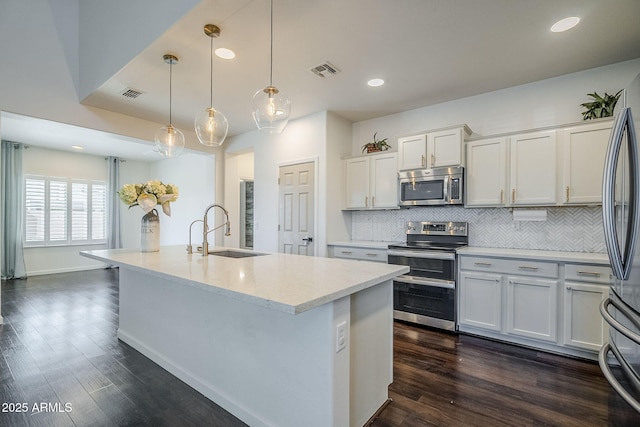 10925 E Toluca Ave, Mesa, AZ 85212 - kitchen featuring stainless steel appliances, a sink, tasteful backsplash, dark wood finished floors, and recessed lighting