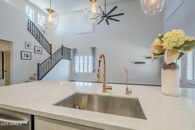 10925 E Toluca Ave, Mesa, AZ 85212 - kitchen featuring a sink, a high ceiling, healthy amount of natural light, and decorative light fixtures