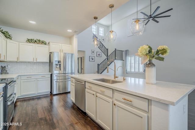 10925 E Toluca Ave, Mesa, AZ 85212 - kitchen featuring appliances with stainless steel finishes, a sink, decorative backsplash, white cabinets, and dark wood-style flooring