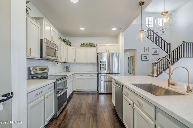 10925 E Toluca Ave, Mesa, AZ 85212 - kitchen with stainless steel appliances, a sink, dark wood-style floors, light countertops, and recessed lighting
