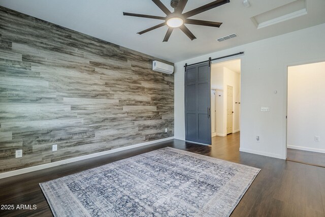 10925 E Toluca Ave, Mesa, AZ 85212 - bedroom featuring a barn door, dark wood-type flooring, an AC wall unit, baseboards, and ceiling fan