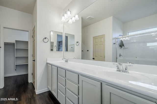 10925 E Toluca Ave, Mesa, AZ 85212 - bathroom with wood finished floors, double vanity, a spacious closet, and baseboards
