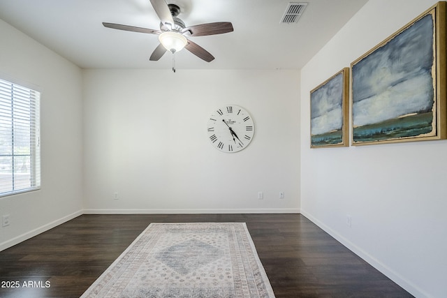 10925 E Toluca Ave, Mesa, AZ 85212 - empty room with a ceiling fan, dark wood-style floors, and baseboards