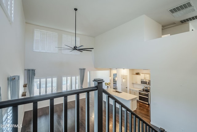 10925 E Toluca Ave, Mesa, AZ 85212 - staircase with wood finished floors, ceiling fan, baseboards, and a high ceiling