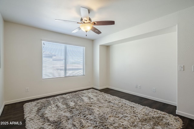 10925 E Toluca Ave, Mesa, AZ 85212 - spare room featuring ceiling fan, baseboards, and dark wood-type flooring