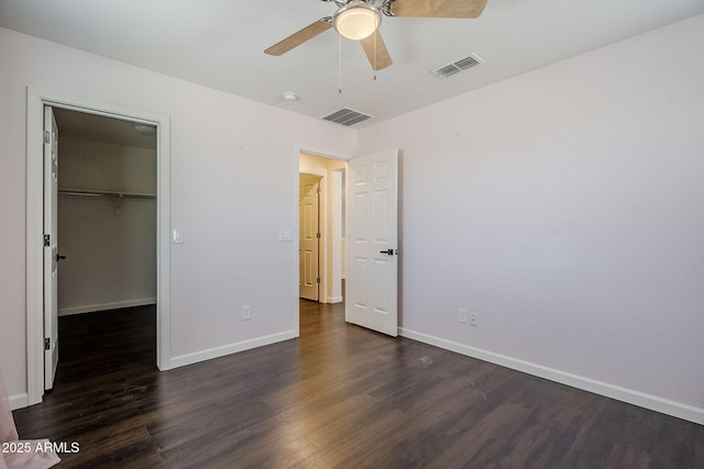 10925 E Toluca Ave, Mesa, AZ 85212 - unfurnished bedroom featuring dark wood-type flooring, baseboards, a spacious closet, ceiling fan, and a closet