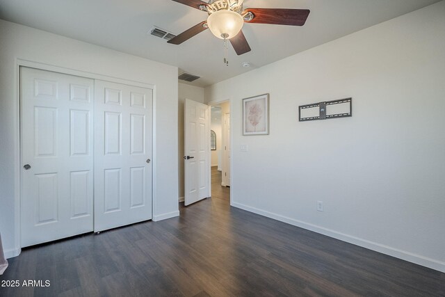 10925 E Toluca Ave, Mesa, AZ 85212 - unfurnished bedroom with dark wood-type flooring, baseboards, a closet, and a ceiling fan