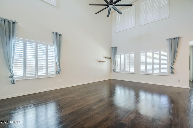10925 E Toluca Ave, Mesa, AZ 85212 - unfurnished room with a towering ceiling, ceiling fan, baseboards, and dark wood-style flooring