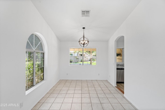 1203 W Escuda Rd, Phoenix, AZ 85027 - spare room with light tile patterned floors, a chandelier, and arched walkways
