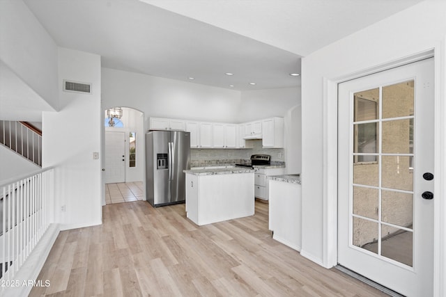 1203 W Escuda Rd, Phoenix, AZ 85027 - kitchen with stainless steel appliances, white cabinetry, a kitchen island, light wood finished floors, and light stone counters