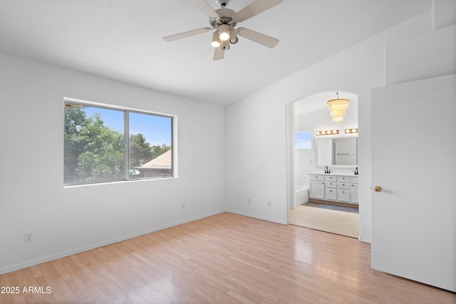 1203 W Escuda Rd, Phoenix, AZ 85027 - spare room with light wood-type flooring, ceiling fan, and arched walkways