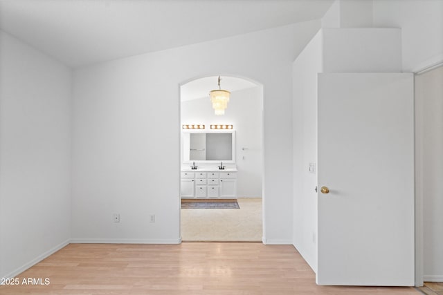 1203 W Escuda Rd, Phoenix, AZ 85027 - empty room with light wood-style flooring and arched walkways