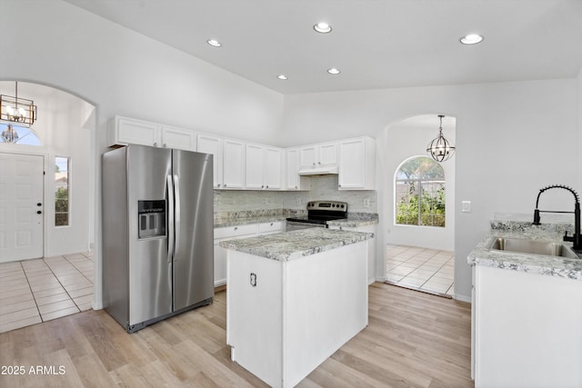 1203 W Escuda Rd, Phoenix, AZ 85027 - kitchen featuring appliances with stainless steel finishes, arched walkways, a chandelier, a kitchen island, and recessed lighting