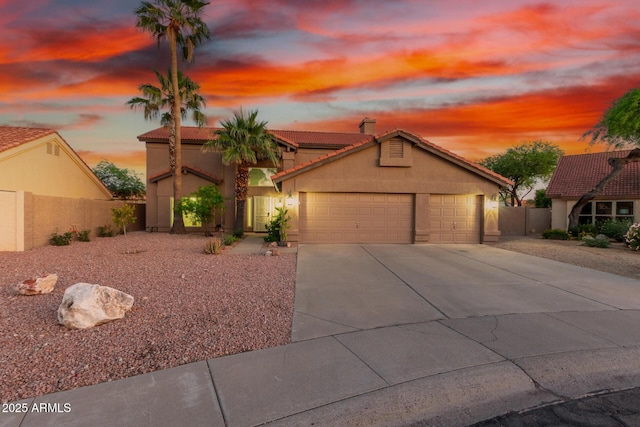 3805 E Desert Flower Ln, Phoenix, AZ 85044 - mediterranean / spanish-style house with a tile roof, stucco siding, a garage, concrete driveway, and fence